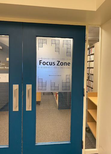 Photo of a glass door with the sign "Focus Zone"