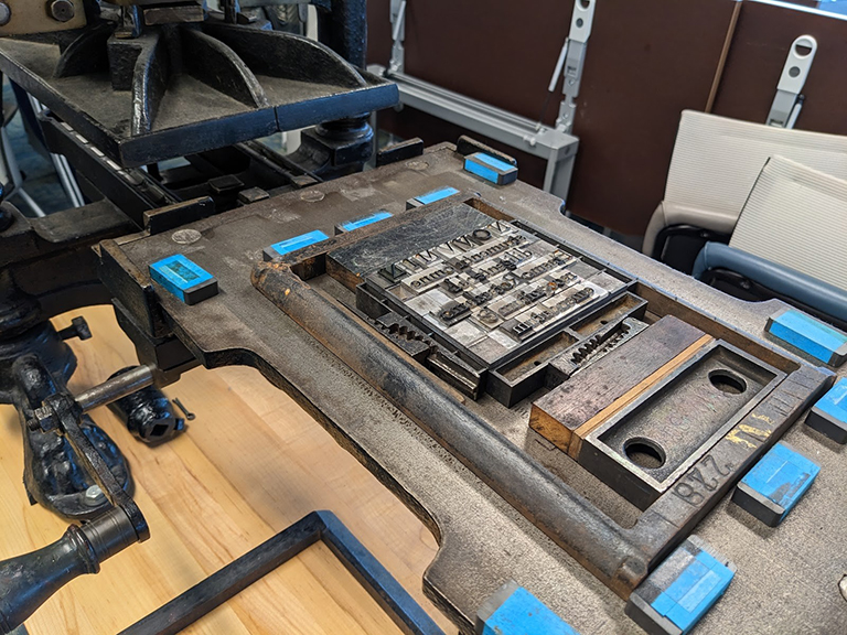 A type form positioned on the bed of the Library’s Albion printing press