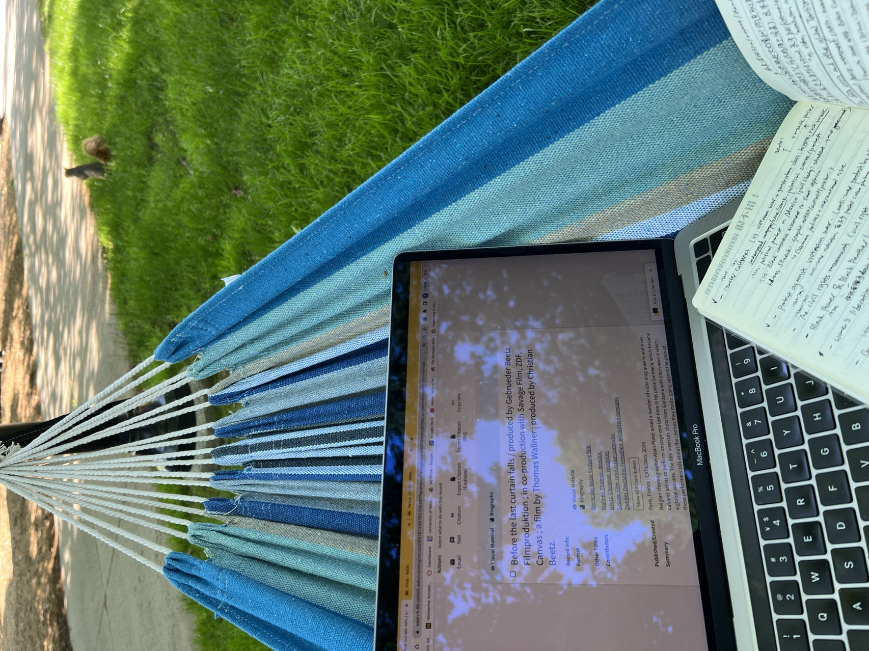 The author's computer and notebook placed on a hammock