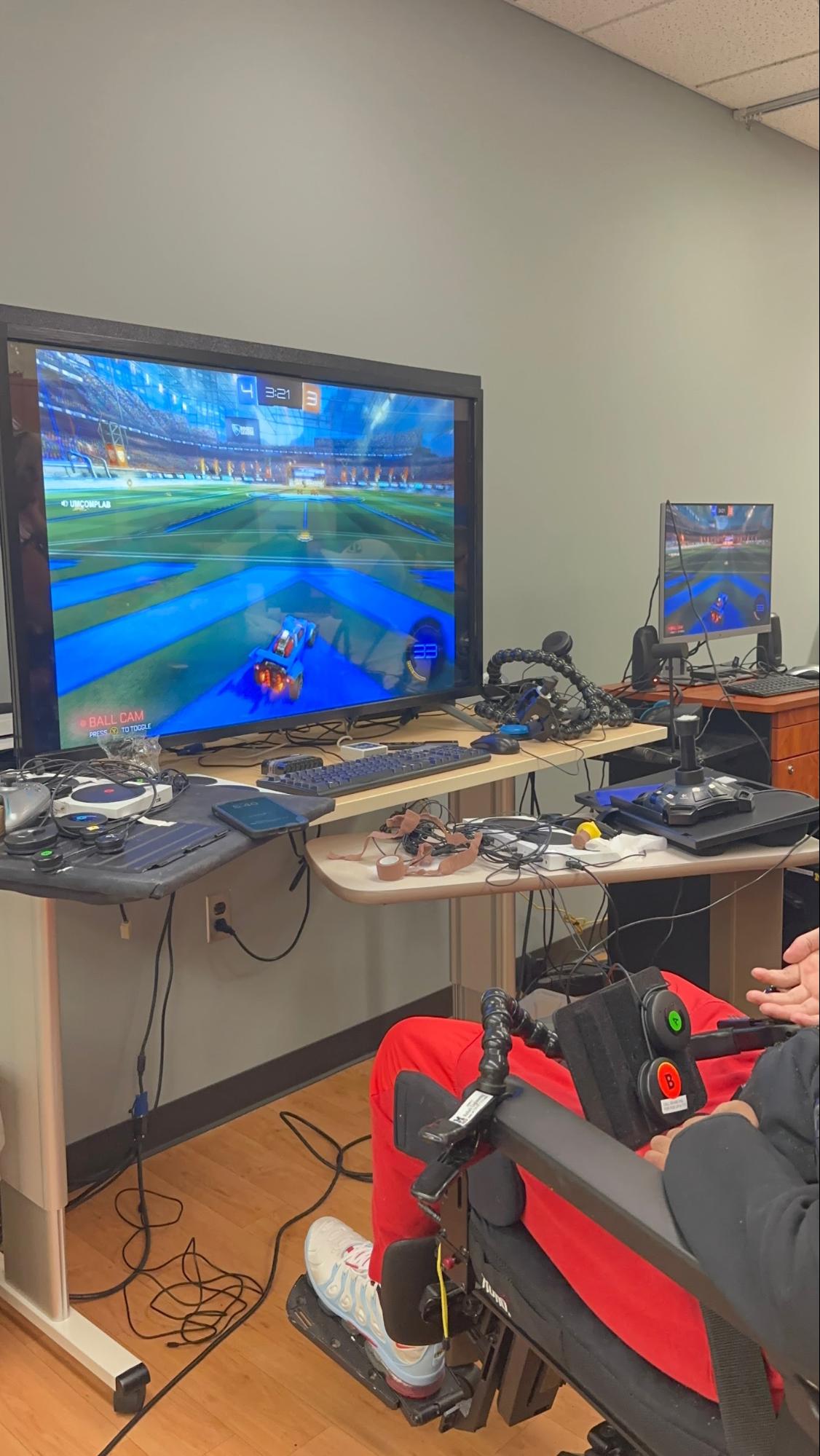 a gamer playing Rocket League using adaptive gaming controllers