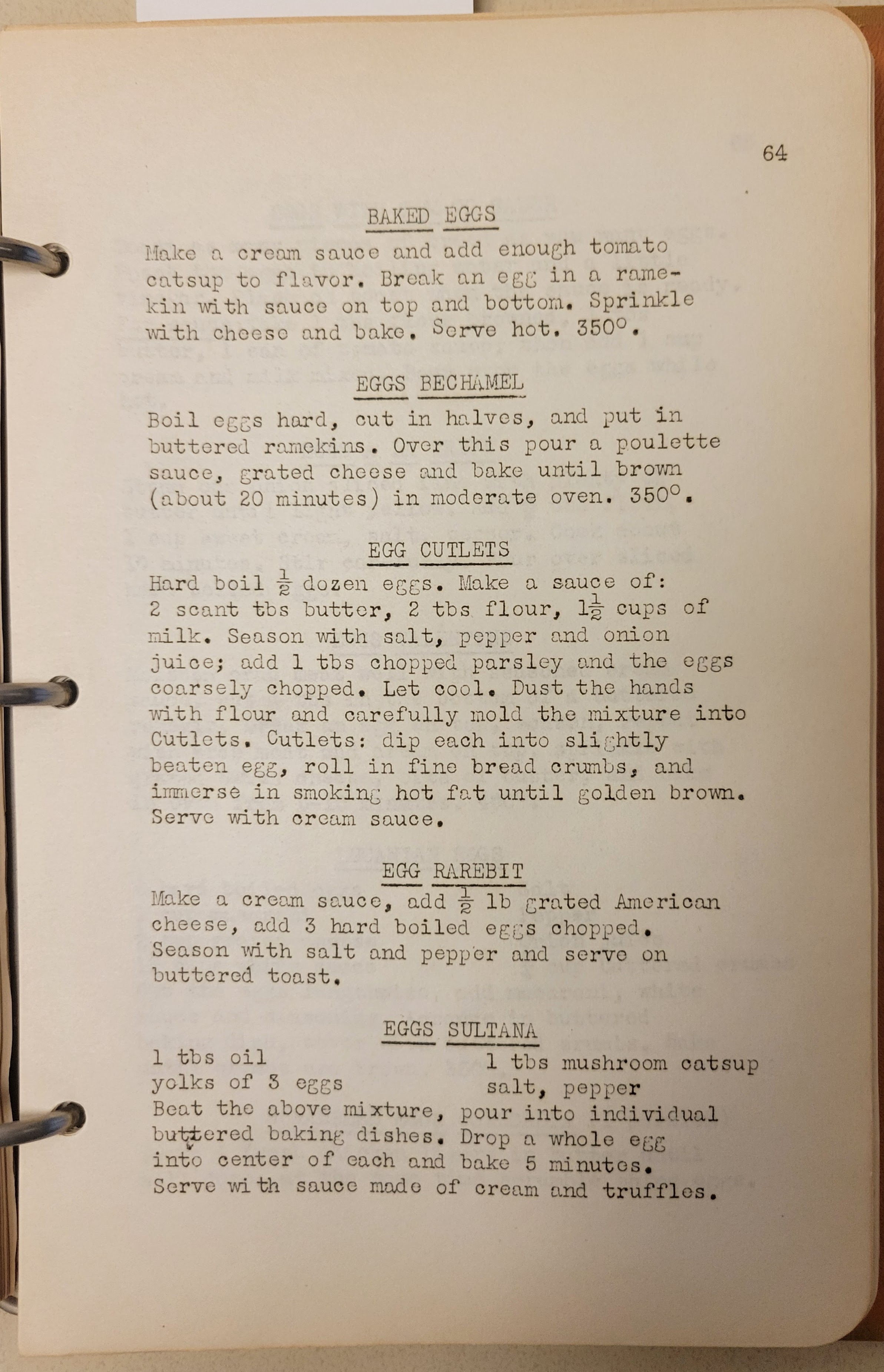 typewritten page in a 3-ring binder with recipes for several egg dishes including baked eggs, eggs bechamel and egg cutlets