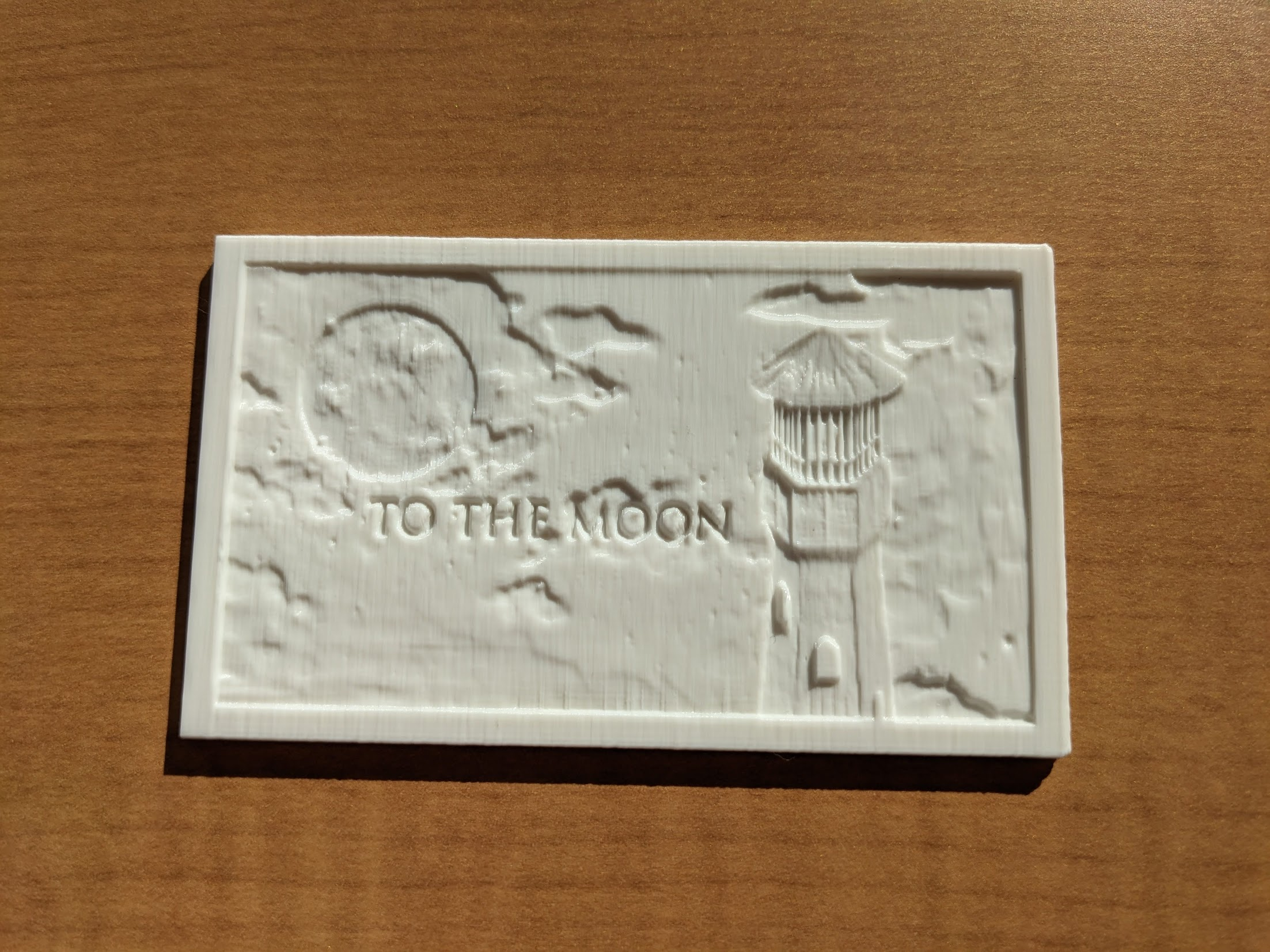 3d printed white lithophane lying face up on desk