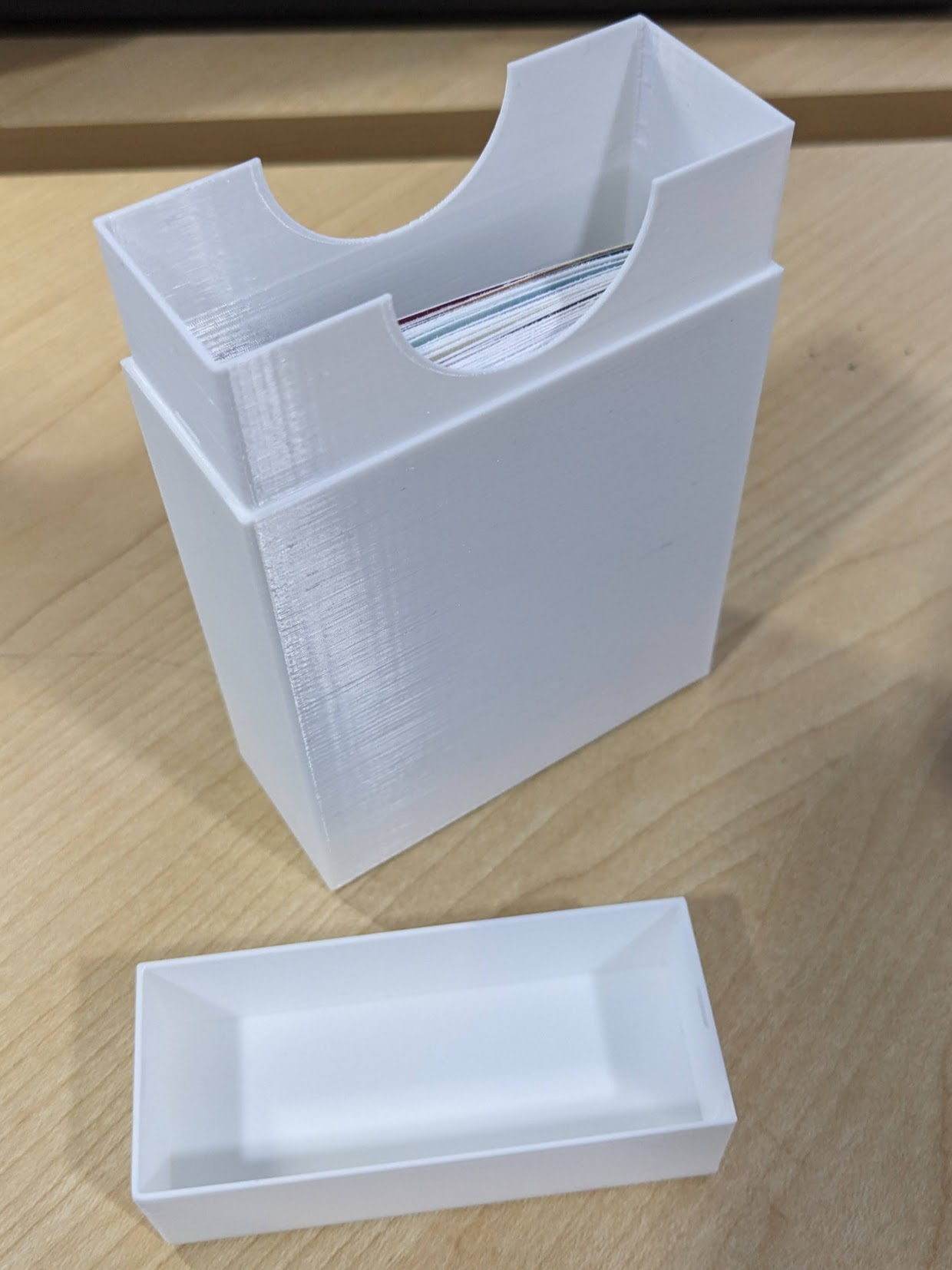 White 3D printed box with tabletop game cards inside.