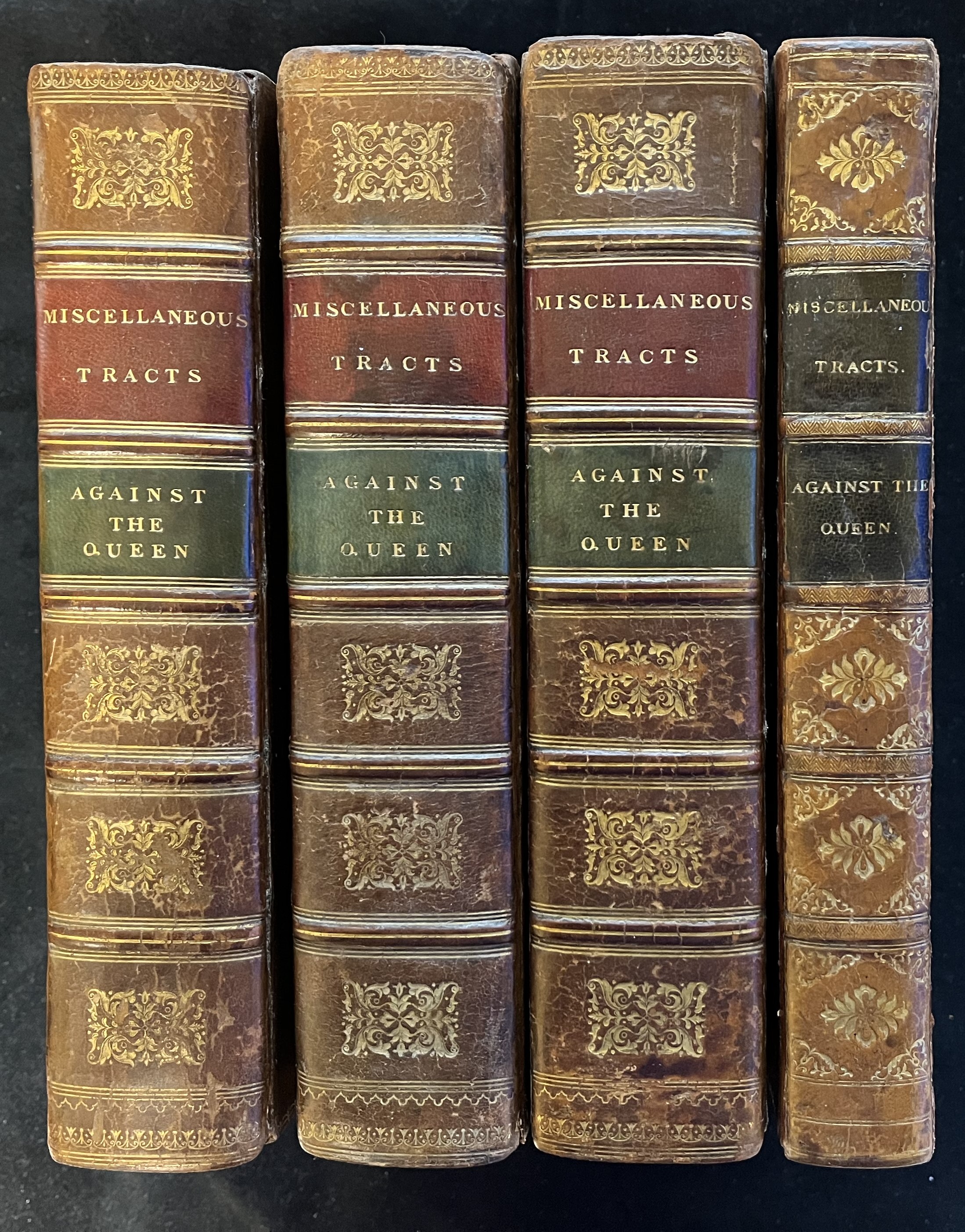 Image of the spines of the four volumes containing 58 imprints against the Queen's cause.