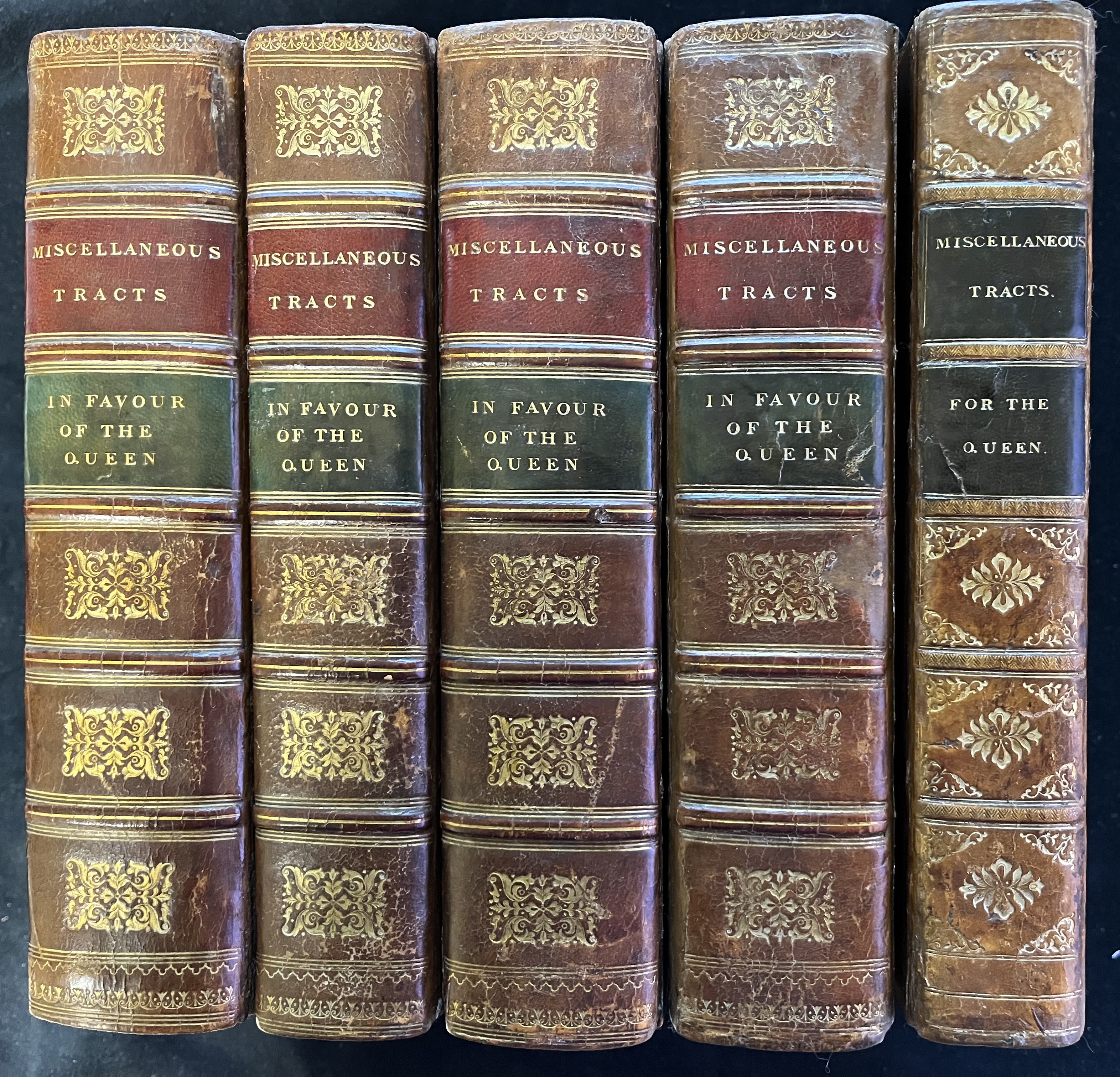 Image of the spines of the five volumes containing 106 imprints in favor of the Queen's cause.