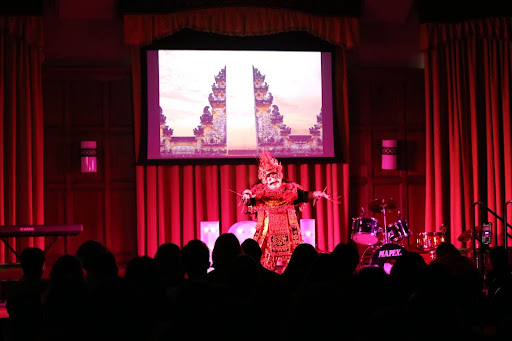 Photo shows a dancer performing a Balinese dance on a stage.
