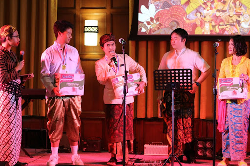 Showing a stage of participants in a cultural 'Best Costume' competition.