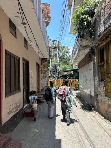 Manvinder Gill walking down a street in Punjab with two others.