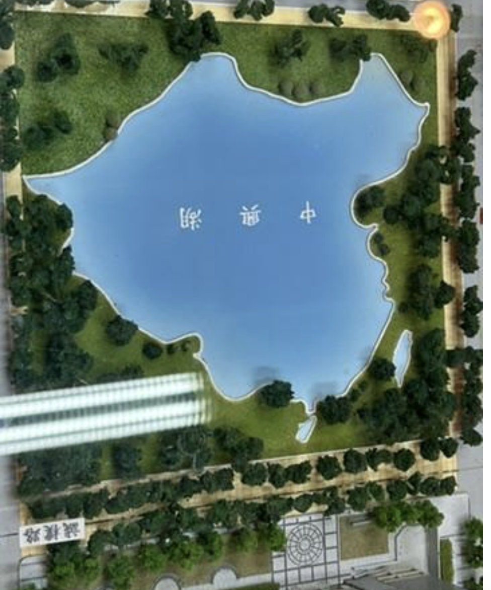 Campus history gallery at National Chung Hsing University displaying a model of “Zhongxing Lake,” shaped like a map of China that includes Taiwan. Staff explained that Zhongxing (中興) evokes “revival,” a name chosen by political elites of the Kuomintang who, after losing the Chinese Civil War and retreating to Taiwan, still envisioned counterattacking the Mainland to complete a national revival.