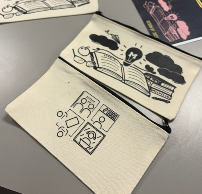 The two winning designs of the design contest applied to pencil cases.