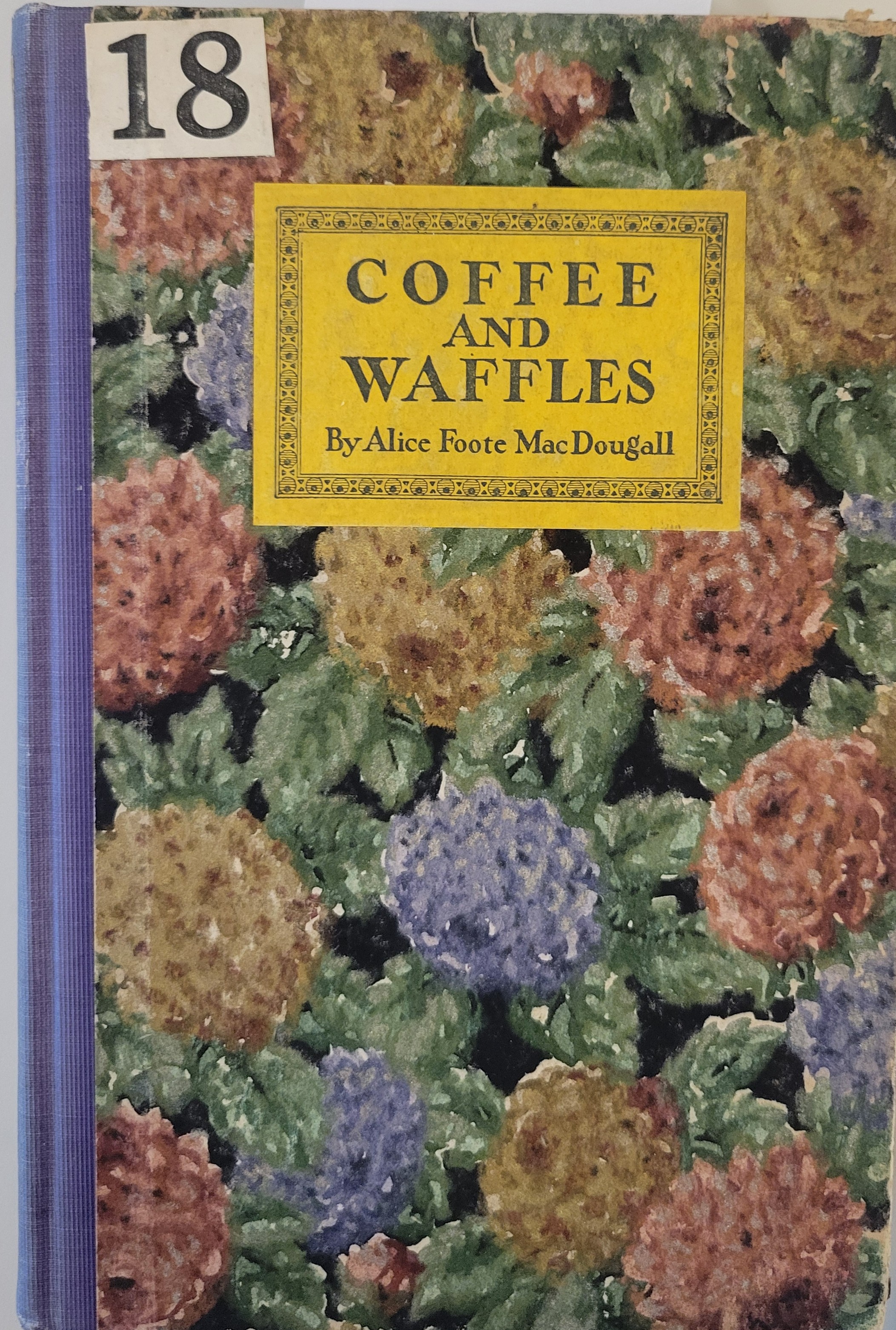 Book cover with blue, pink, and yellow hydrangea floral pattern and the book title on a yellow rectangle on top of that