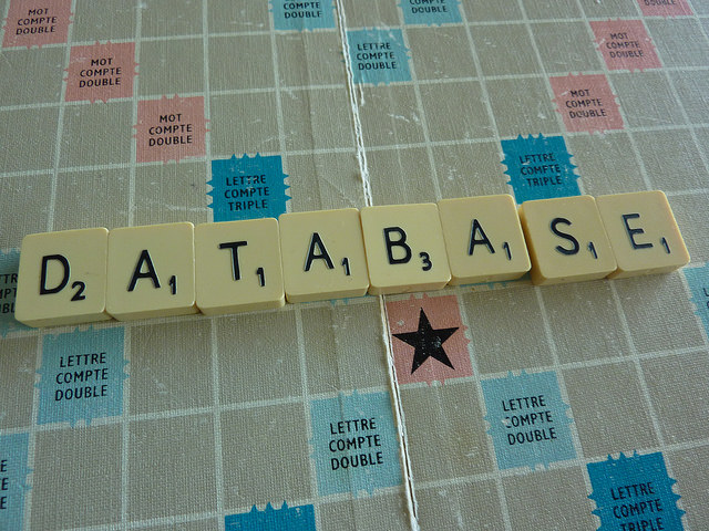 Scrabble tiles spell out "database."