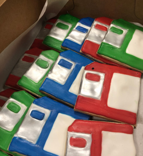 A box of sugar cookies decorated to look like 3.5-inch floppy disks