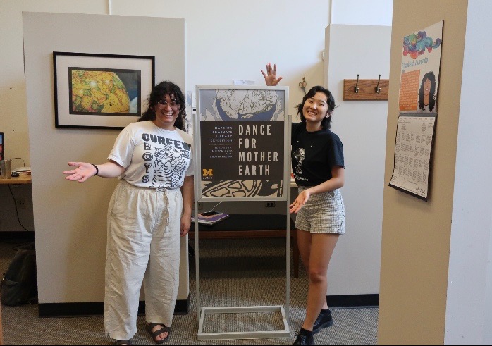 Interns with exhibit poster