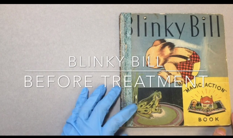 screen capture of the opening a video with title and gloved hand on cover of book