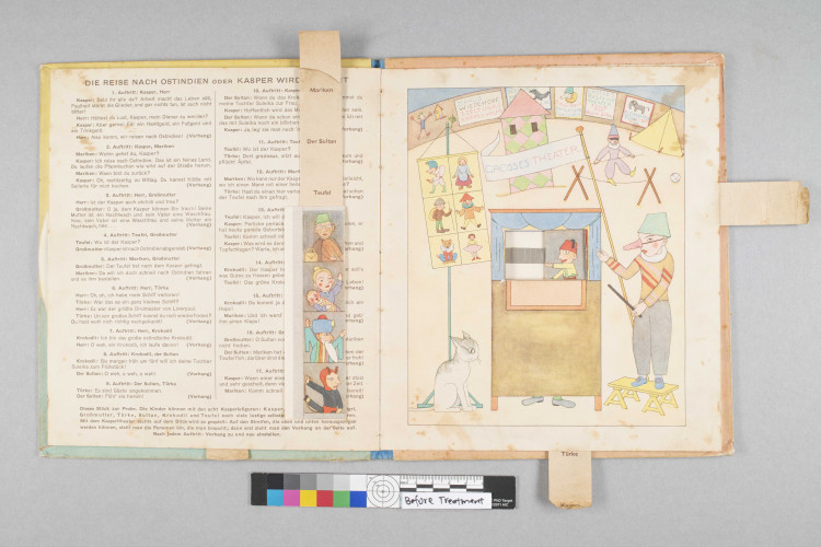 view of open book with colored drawings and pull tabs visible 