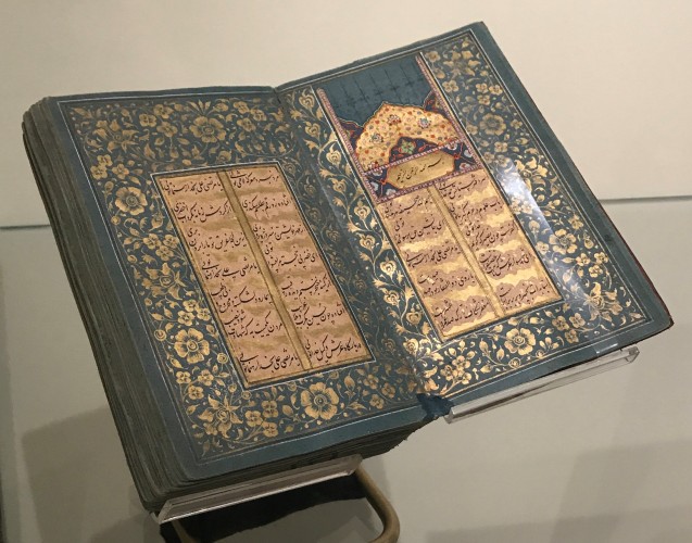 View of Islamic Manuscript 350 on display with illuminated opening featured