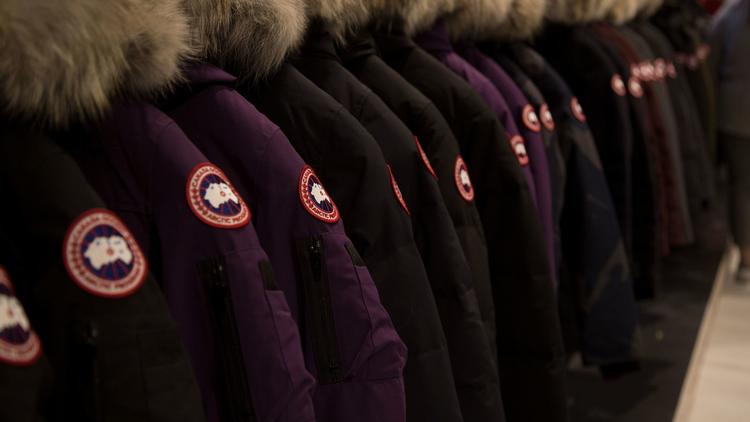 Image of a line of Canada Goose jackets on a rack