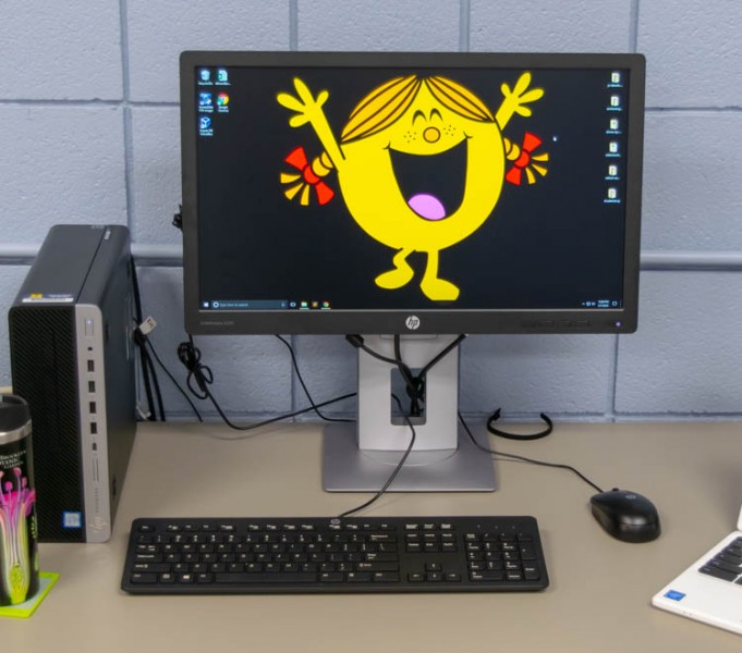 Picture of a workstation with a happy cartoon character as the desktop image 