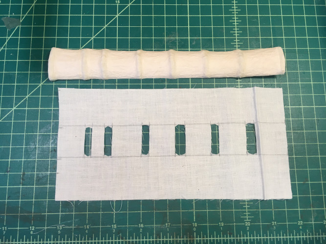 Slotted cotton muslin lining to go over the molded spine-former, holding it in place