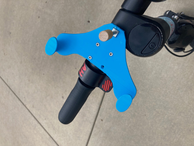 Blue 3d printed phone holder mounted to motorized scooter handlebar