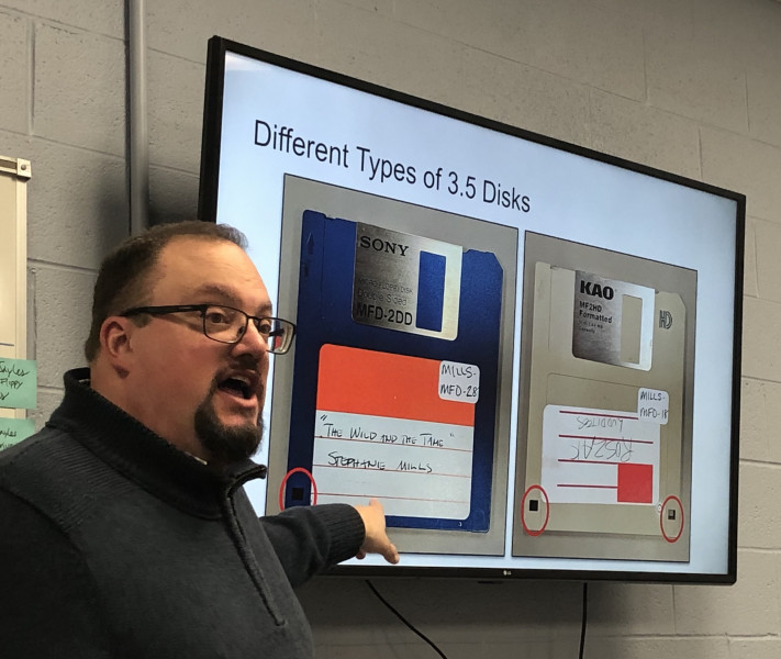 Lance Stuchell, Head of the Digital Preservation Unit, points at a screen display of 3.5-inch floppy disks during a World Digital Preservation Day event.