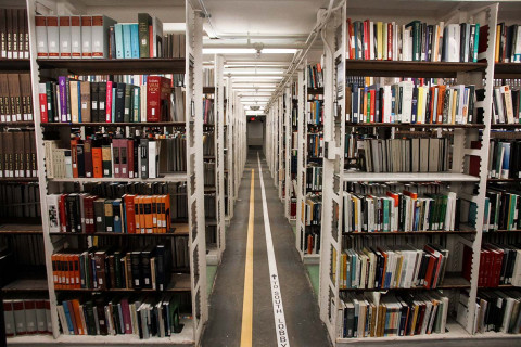 A path through the Hatcher North stacks with yellow and white directional lines on the floor.