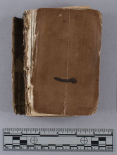View of upper leather cover of book under discussion with ruler