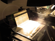 Image of tightly bound book being digitized on Quartz A1-V book scanner
