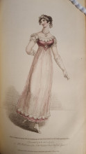 Woman dancing in a pink and white, ankle-length ball gown with empire waist. Hair is pulled back with a headband and put up in ringlets at the back of her head.