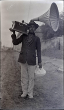 Image of man in uniform carrying a gramophone on his shoulder