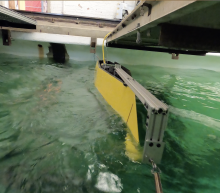 Yellow naval vessel in the marine laboratory wave tank