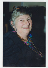 Head and shoulders photograph of a smiling white woman with short gray hair.