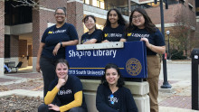 image of library ambassadors with Shapiro Library sign