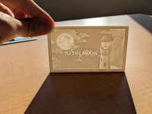 White 3d printed lithophane standing on table lit from the back in the sun 