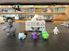 3d printed testtube rack and selection of small 3d printed figurines on lab table 