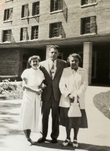 Lila McMechan standing in front of dormitory with her parents