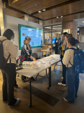 Students in the Shapiro lobby creating pronoun pins.