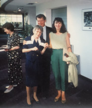 BJ Busch standing next to two colleagues at her retirement party