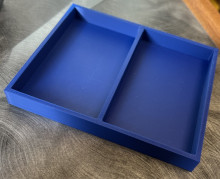 A blue 3D printed rectangular tray, with a divider down the middle vertically.