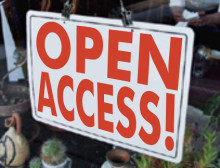 Sign hanging in a shop window that says OPEN ACCESS!