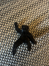 Black 3d printed mini figurine on a wicker table