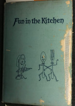 Blue book cover reading "Fun in the Kitchen" with line drawings of anthropomorphized cutlery