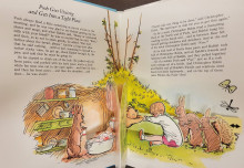 colorful pop-up book opening with text and story scene of characters Pooh Bear, Rabbit, and Christopher Robin