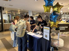Two students being welcomed into the event. 