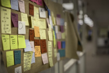 Photo of Post-It notes covering a wall in the Shapiro Design Lab by Bethany Hayden