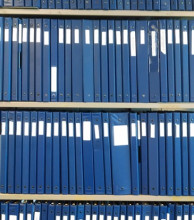 Photo of blue binders on shelves in Special Collections Reading Room