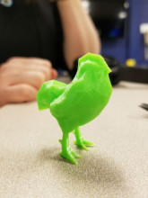 Small green 3D-printed rooster