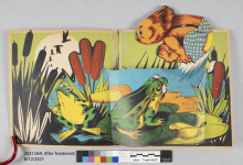 image of an open pop-up book with view of koala bear leaping into pond surrounded by cattails and frogs