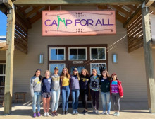 Image of students in front of camp sign